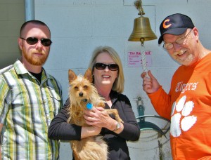 Pictured left to right, Todd Waldrep, Beth Dettmann, holding adoptable dog “Zack,” and Rick Dettmann